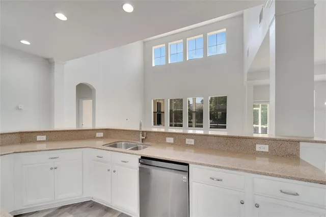 an aerial view of a house with outdoor space and a lake view in back