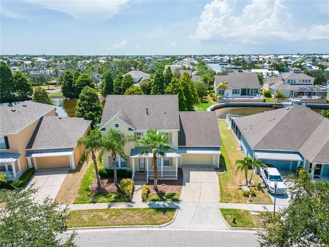 a view of a house with a yard and sitting area