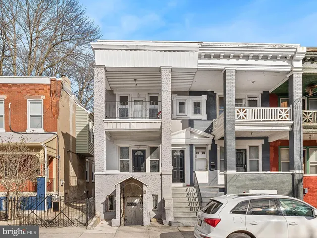 a front view of a building with parking space