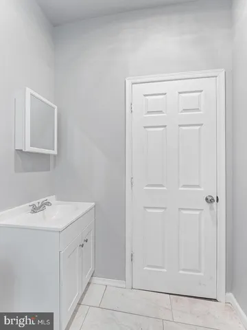 a bathroom with a sink a vanity and a mirror