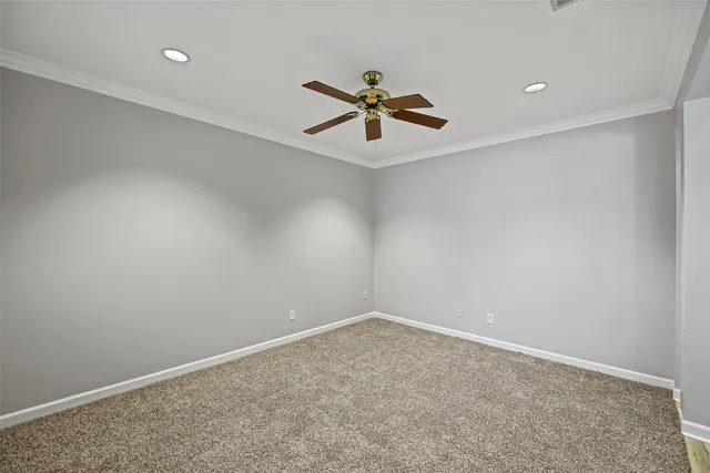 a view of a room with wooden floor and ceiling fan
