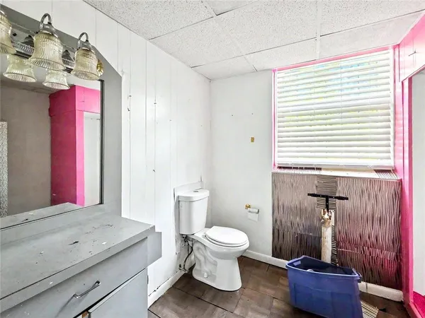a bathroom with a toilet sink and mirror
