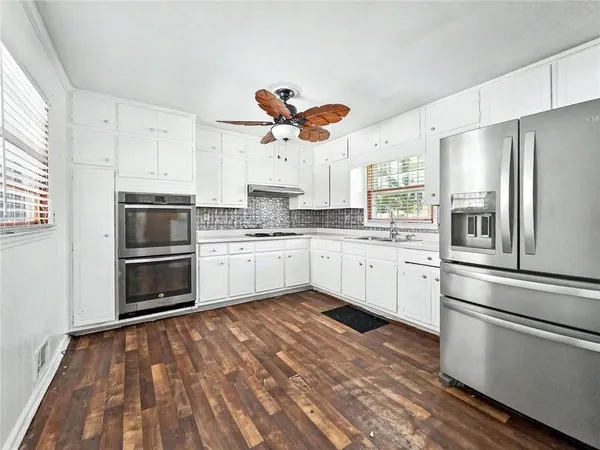 a kitchen with stainless steel appliances a stove a sink and a refrigerator