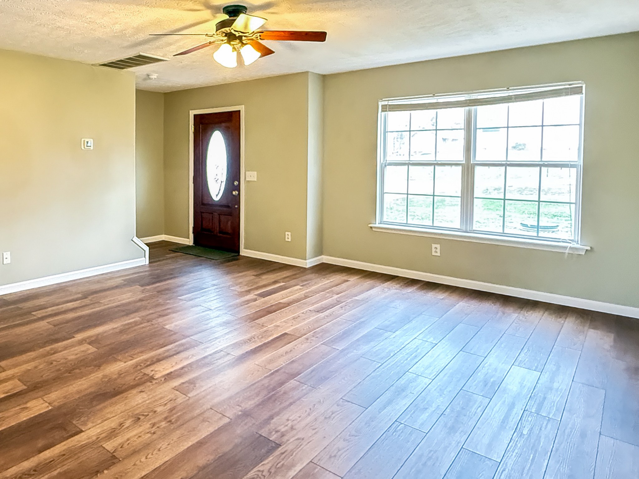 1004 Fall Parkway Murfreesboro, TN 37129 - Photo 5 of 15 a view of an empty room with wooden floor and a window
