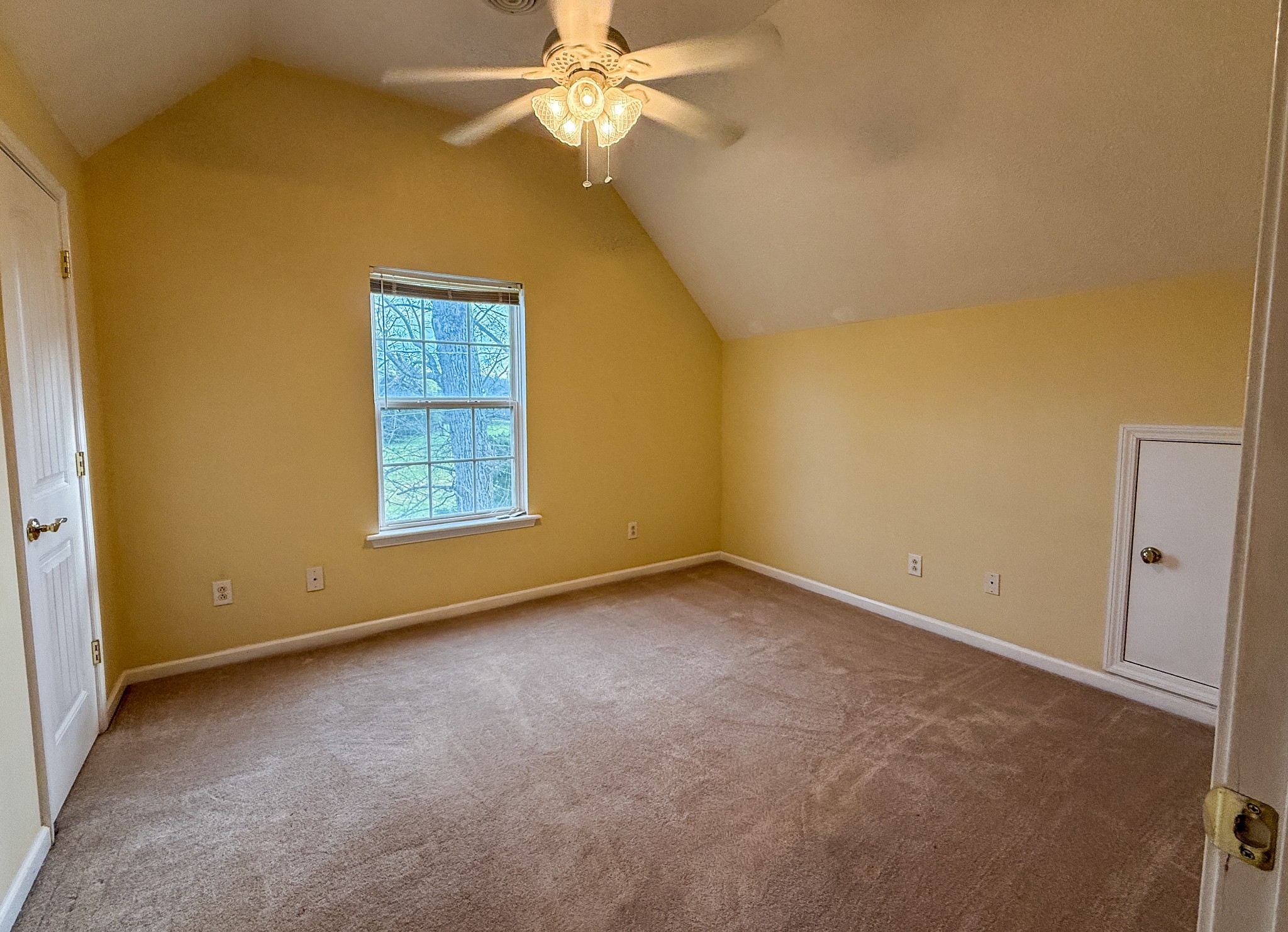 1004 Fall Parkway Murfreesboro, TN 37129 - Photo 8 of 15 an empty room with a chandelier fan and a window