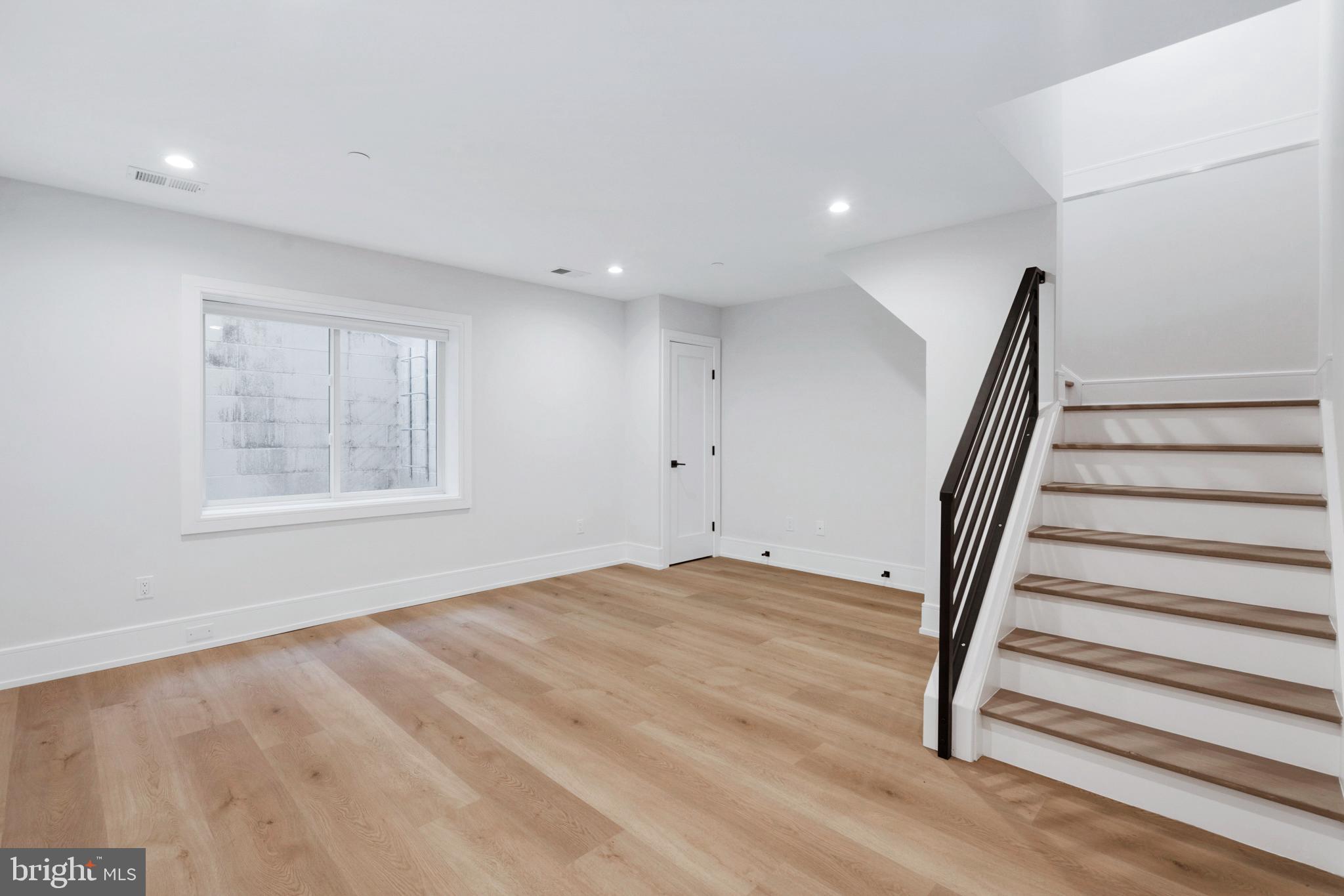 2008 Renaissance Walk, Unit 5 Philadelphia, PA 19145 - Photo 11 of 94 a view of an empty room with wooden floor and stairs