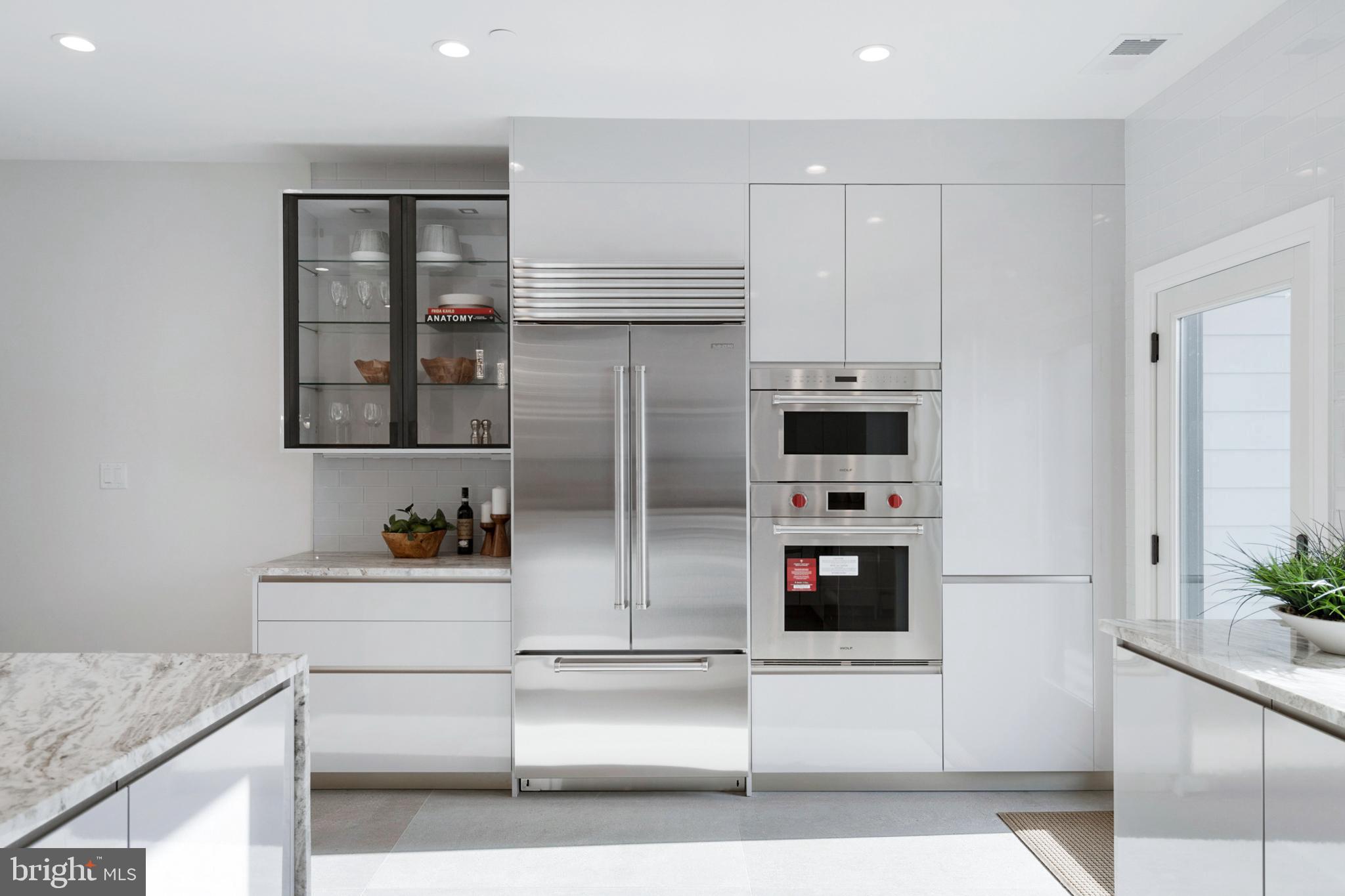 2008 Renaissance Walk, Unit 5 Philadelphia, PA 19145 - Photo 16 of 94 a kitchen with stainless steel appliances kitchen island granite countertop a refrigerator and a stove top oven