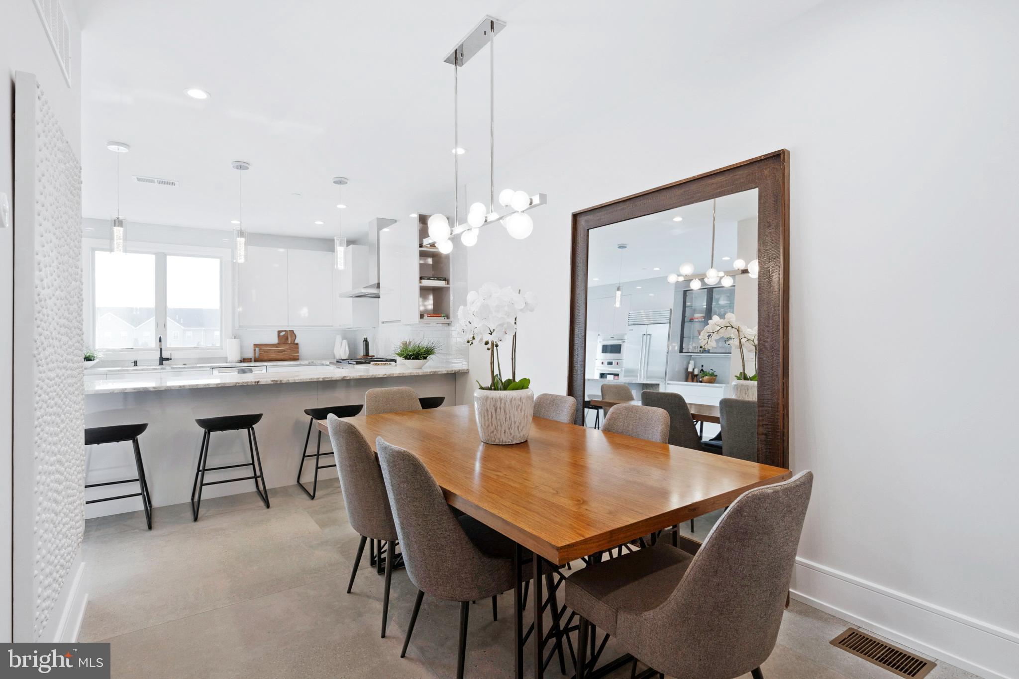 2008 Renaissance Walk, Unit 5 Philadelphia, PA 19145 - Photo 18 of 94 a dining room with a table chairs and a kitchen view