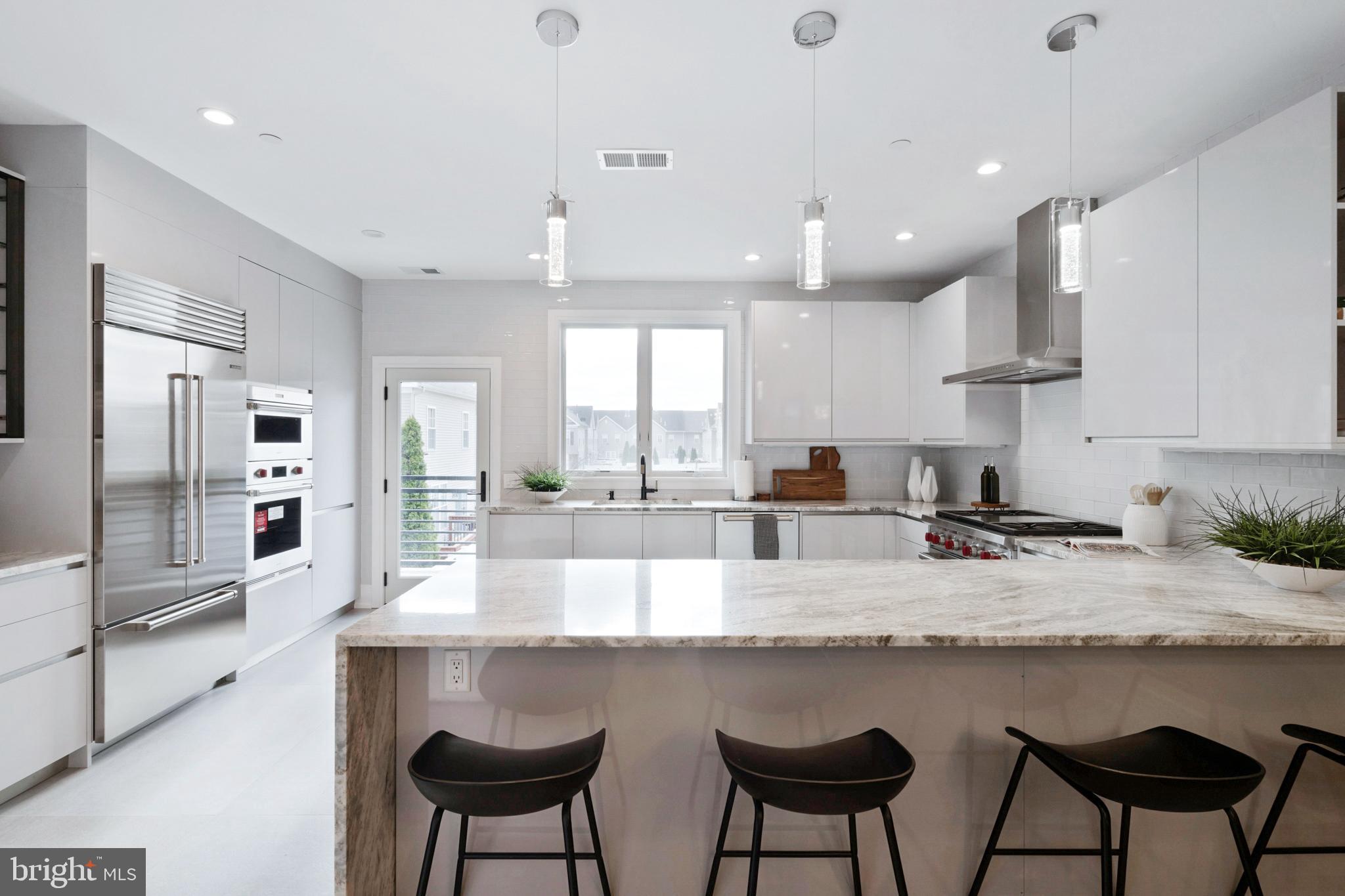2008 Renaissance Walk, Unit 5 Philadelphia, PA 19145 - Photo 25 of 94 a large kitchen with granite countertop a counter top space a sink stainless steel appliances and cabinets