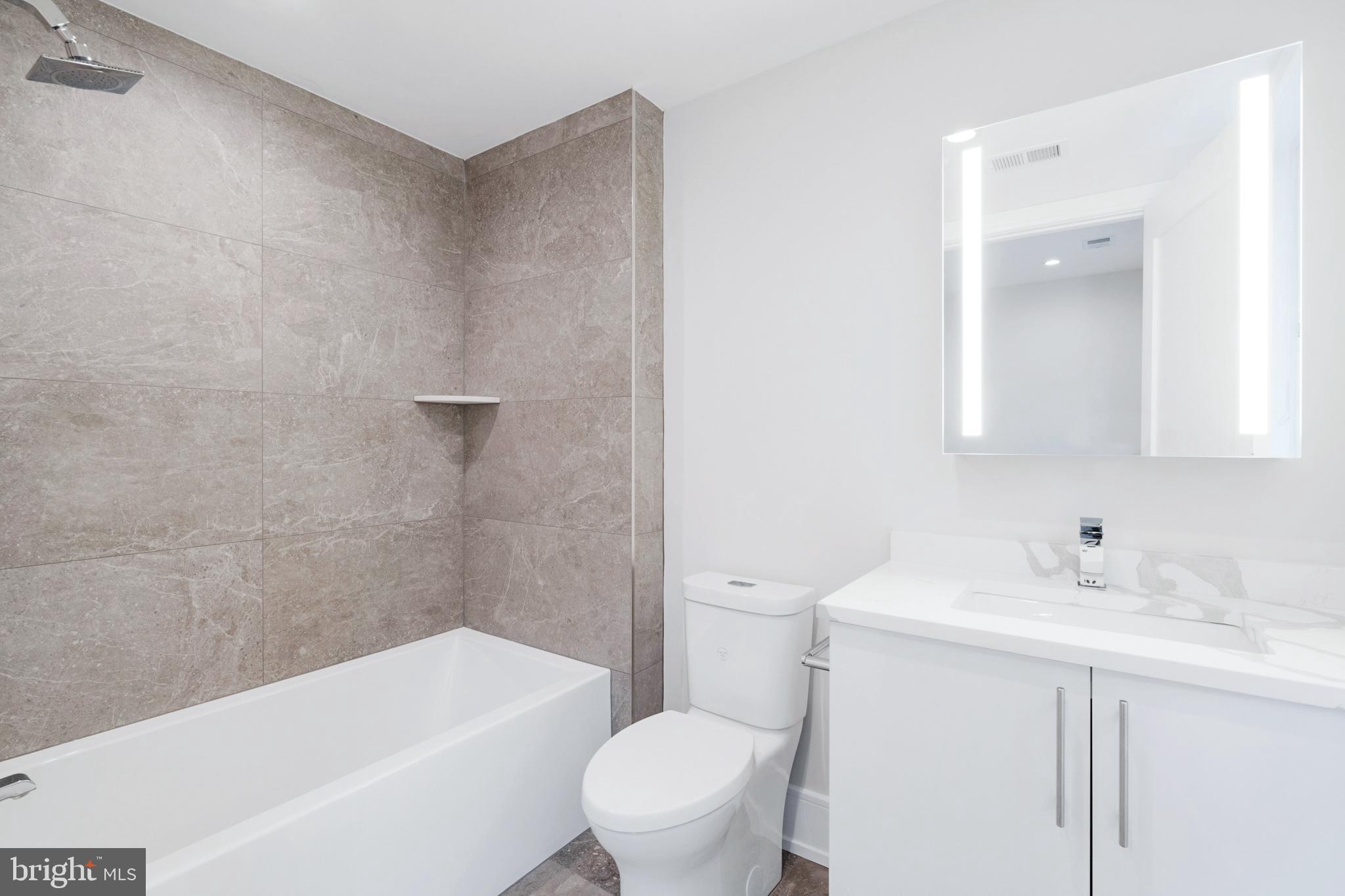 2008 Renaissance Walk, Unit 5 Philadelphia, PA 19145 - Photo 36 of 94 a bathroom with a sink a toilet and a bathtub