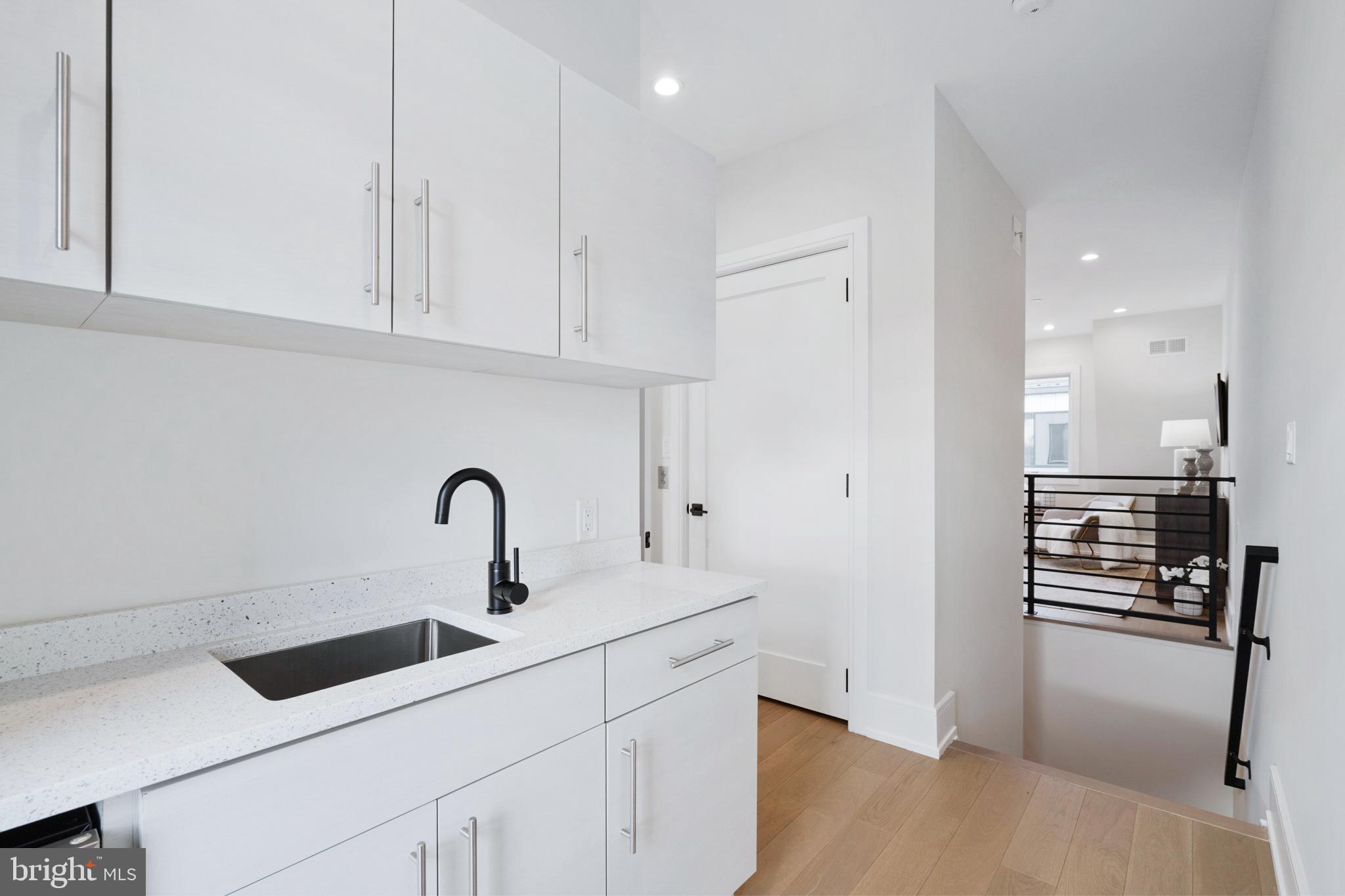 2008 Renaissance Walk, Unit 5 Philadelphia, PA 19145 - Photo 39 of 94 a kitchen with stainless steel appliances a sink a stove and a refrigerator