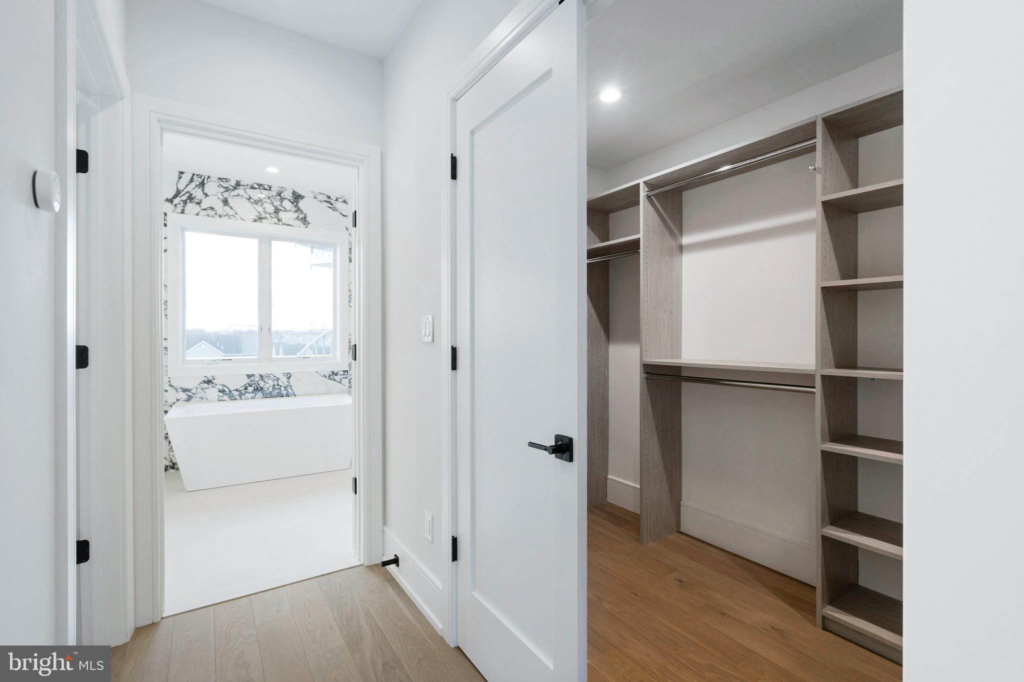 2008 Renaissance Walk, Unit 5 Philadelphia, PA 19145 - Photo 43 of 94 a view of bathroom with a walk in closet and wooden floor