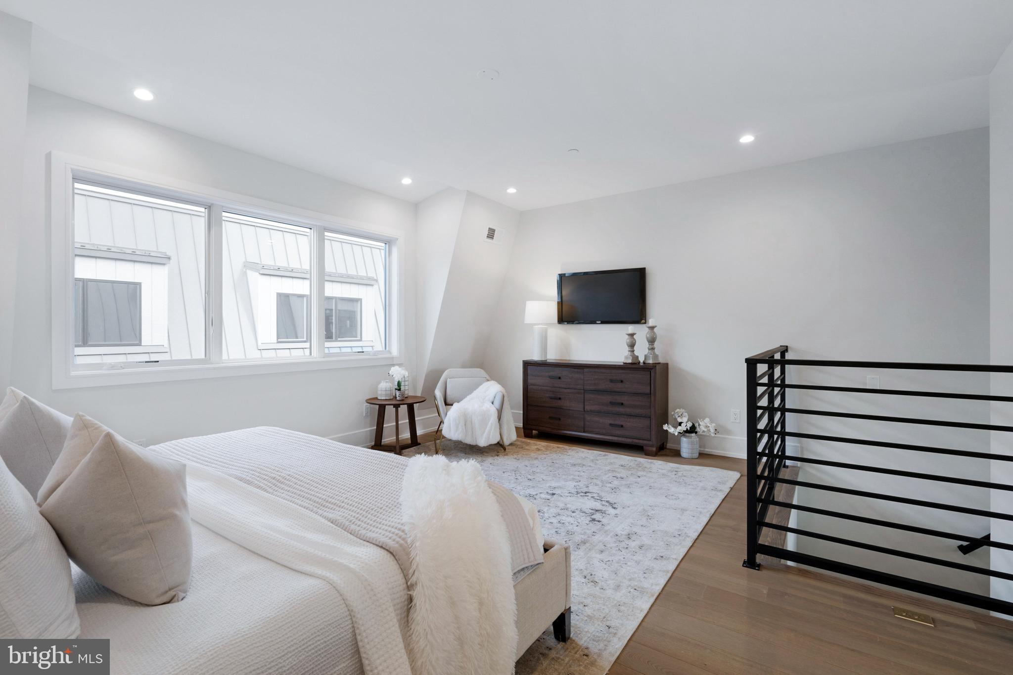 2008 Renaissance Walk, Unit 5 Philadelphia, PA 19145 - Photo 46 of 94 a bedroom with a bed a mirror and a flat screen television