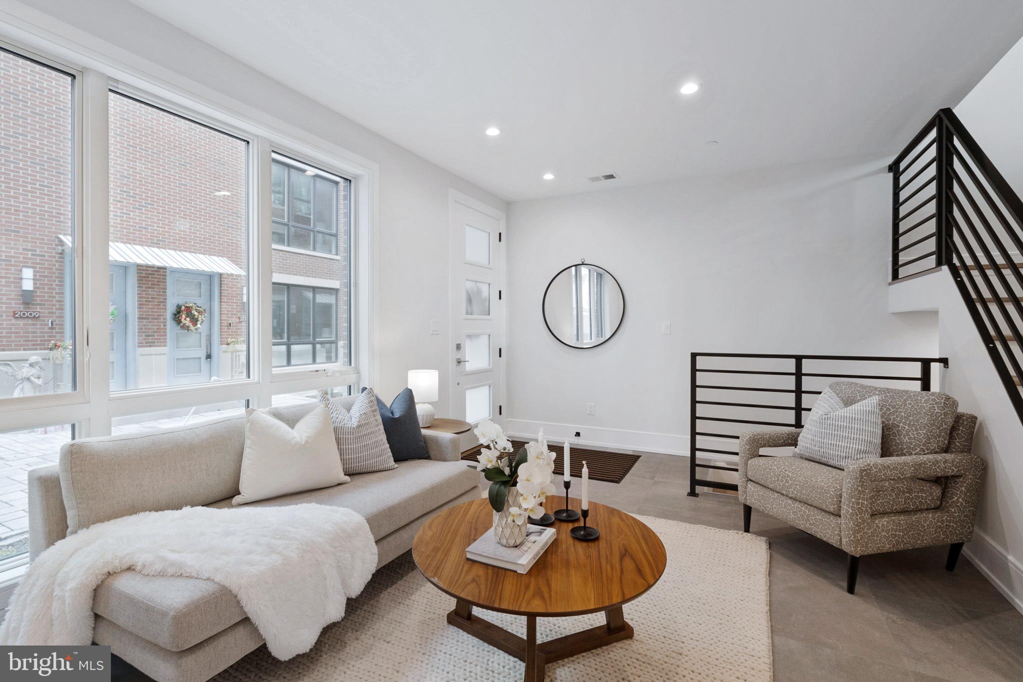 2008 Renaissance Walk, Unit 5 Philadelphia, PA 19145 - Photo 5 of 94 a living room with furniture and a large window
