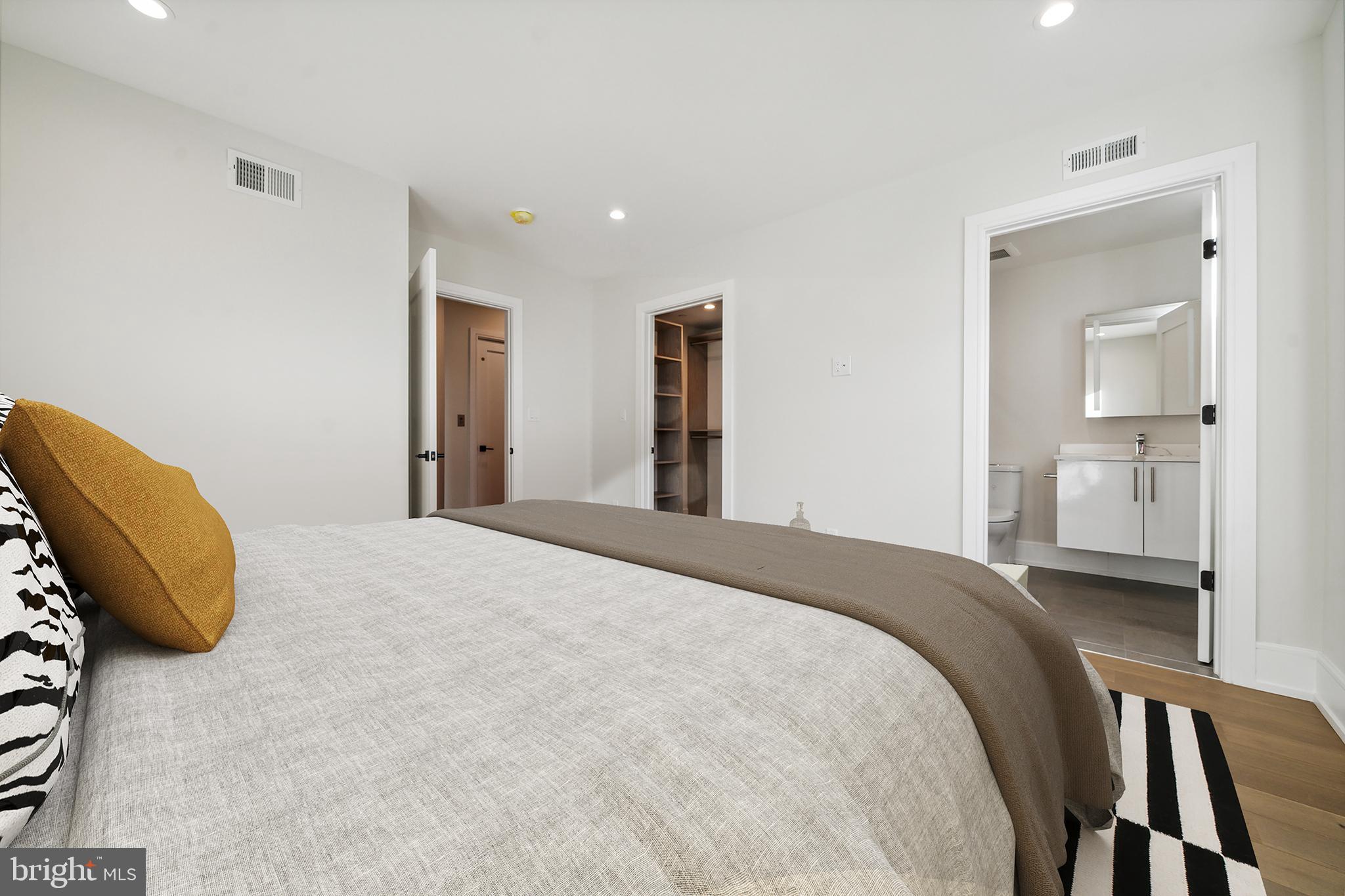 2008 Renaissance Walk, Unit 5 Philadelphia, PA 19145 - Photo 54 of 94 a bedroom with a bed and a mirror