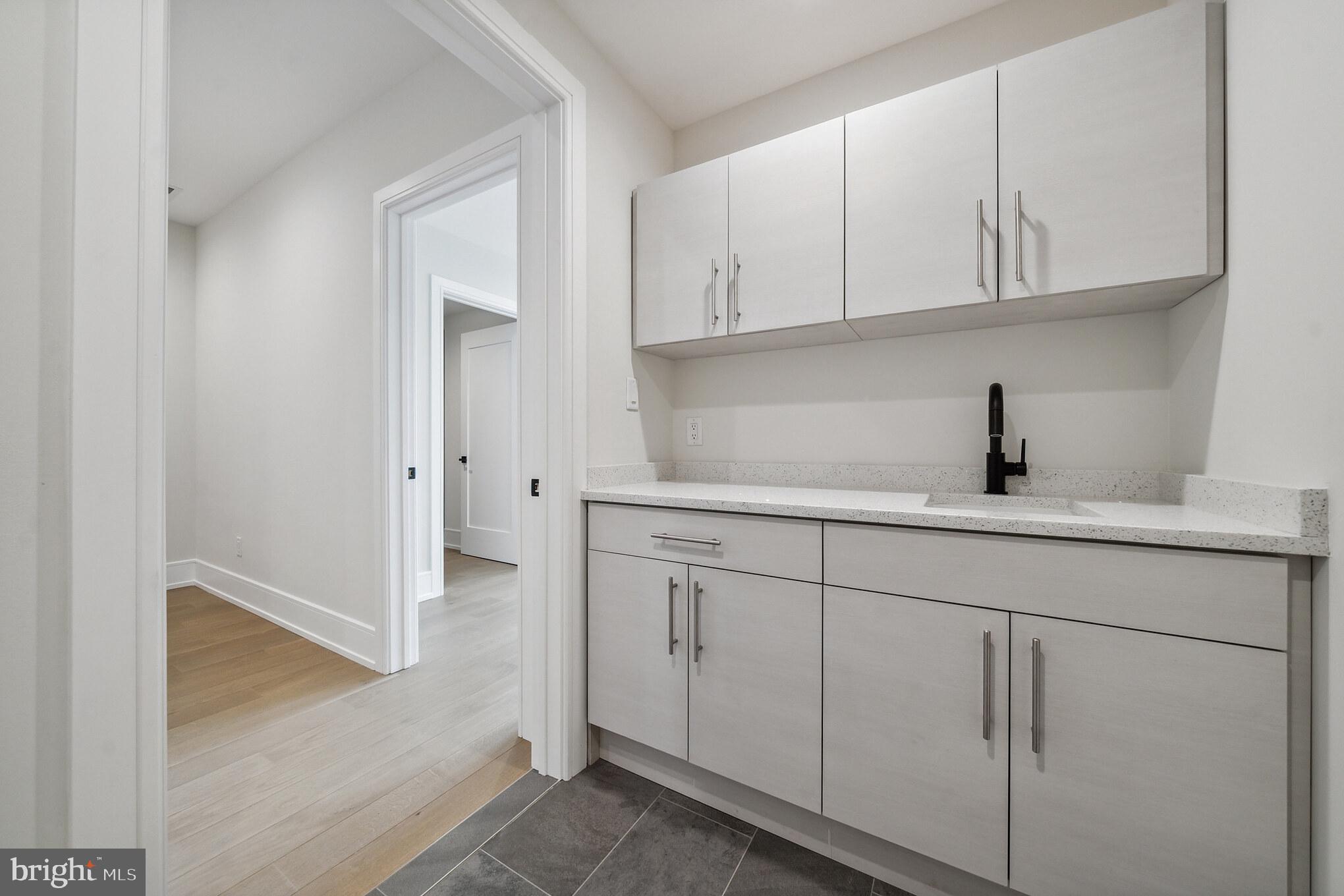 2008 Renaissance Walk, Unit 5 Philadelphia, PA 19145 - Photo 68 of 94 a kitchen with white cabinets and sink
