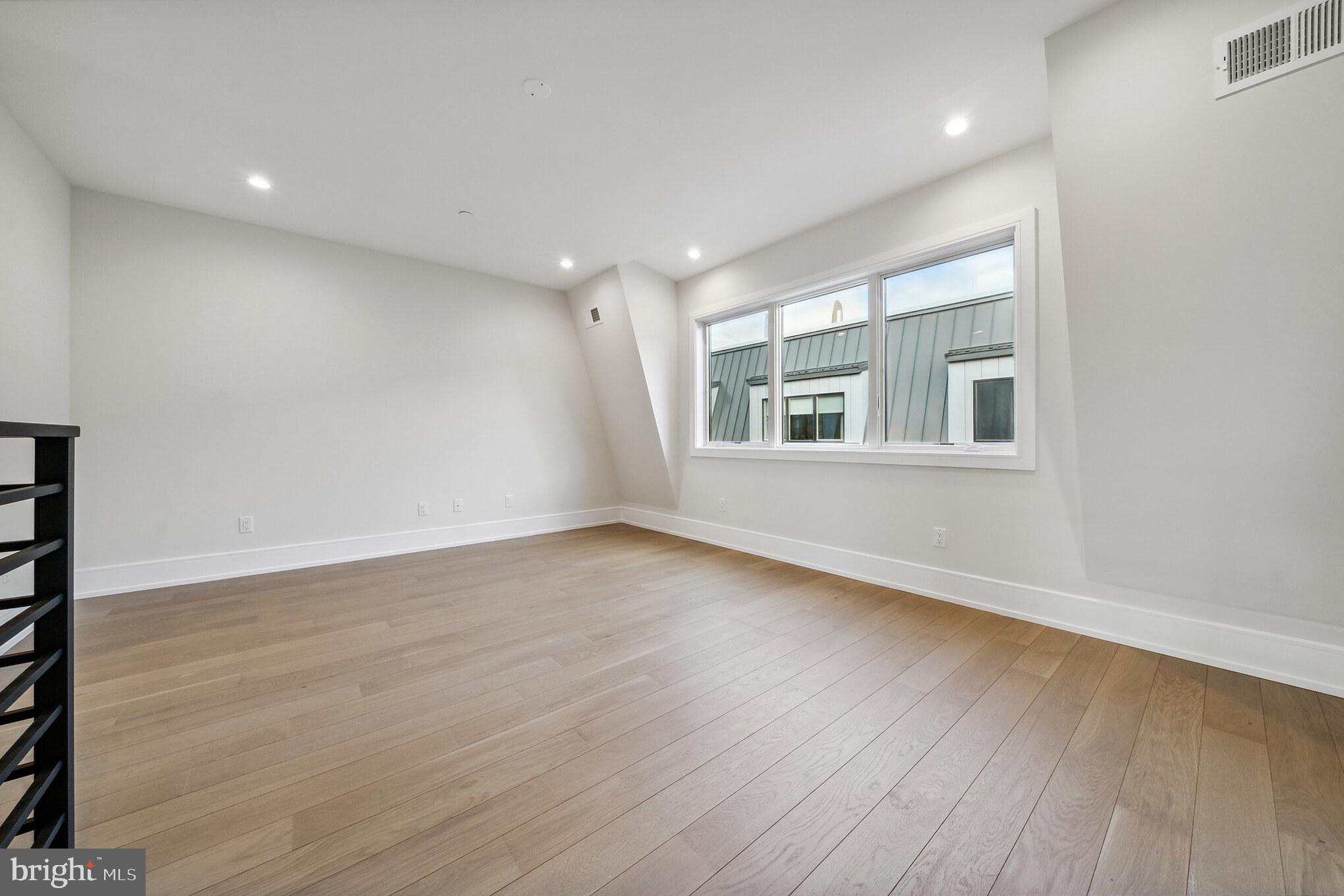2008 Renaissance Walk, Unit 5 Philadelphia, PA 19145 - Photo 79 of 94 wooden floor in an empty room with a window