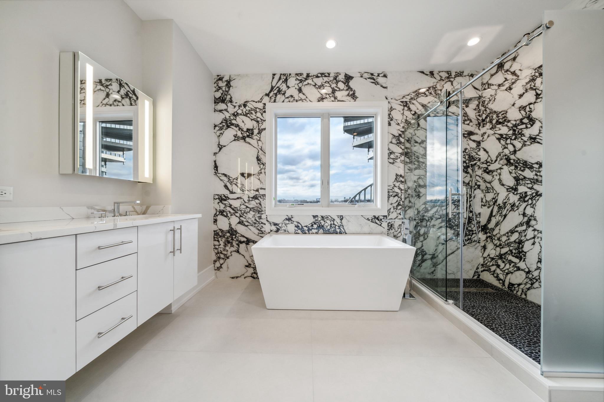 2008 Renaissance Walk, Unit 5 Philadelphia, PA 19145 - Photo 84 of 94 a bathroom with a sink a mirror and a bathtub