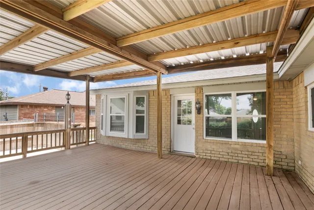 a view of a porch with wooden floor