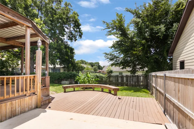 a view of balcony with wooden floor and fence
