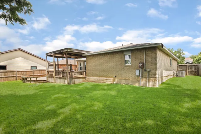 a backyard of a house with table and chairs