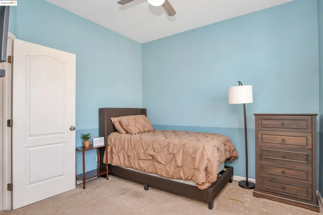 a bedroom with a bed and a lamp