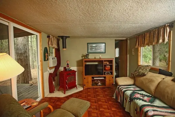 a living room with furniture a large window and a flat screen tv