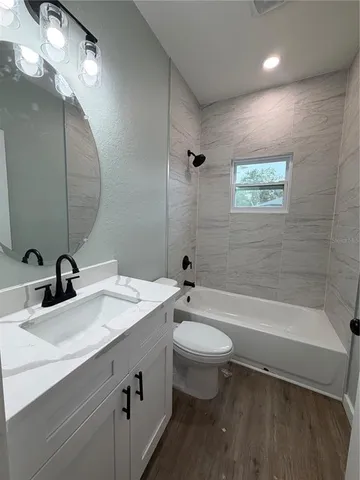 a bathroom with a sink a toilet and bathtub