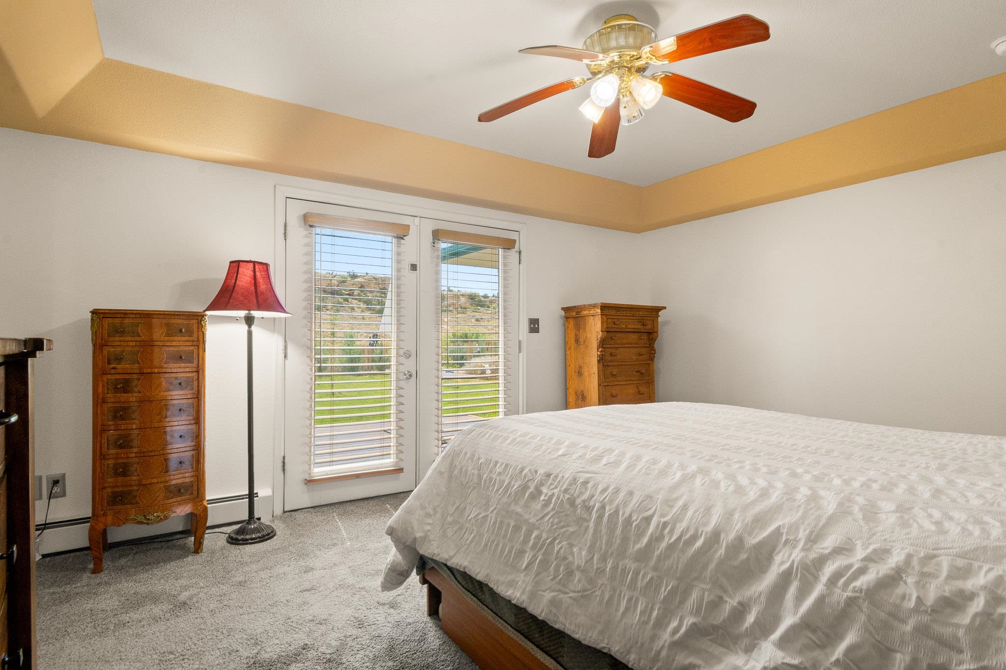 398 Butte Court Grand Junction, CO 81507 - Photo 12 of 33 a bedroom with a bed and a chandelier