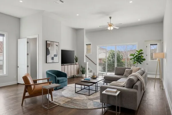 a living room with furniture potted plant and a window