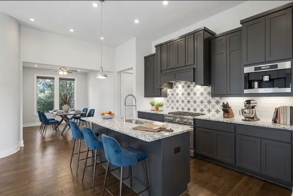 a kitchen with sink cabinets dining table and chairs