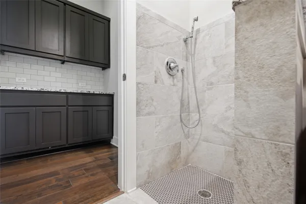 a bathroom with a shower and a sink