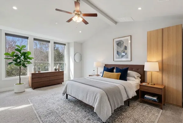 a spacious bedroom with a bed and a chandelier