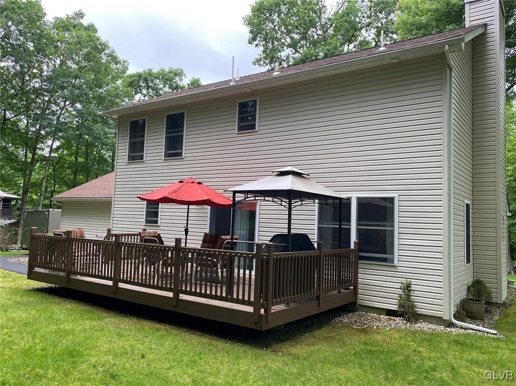 142 Colette Lane Dingmans Ferry, PA 18328 - Photo 11 of 14 a view of a house with a yard and deck