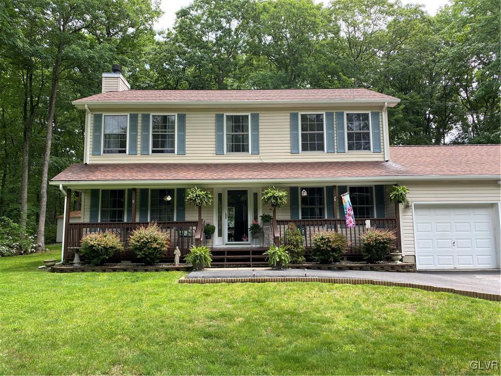 142 Colette Lane Dingmans Ferry, PA 18328 - Photo 3 of 14 a front view of a house with garden