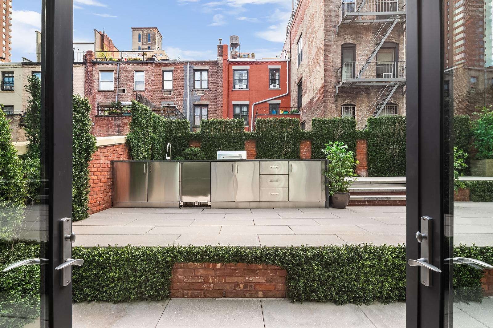 140 West 81st Street, Unit 2B Manhattan, NY 10024 - Photo 18 of 22 a view of a brick house with many windows and plants