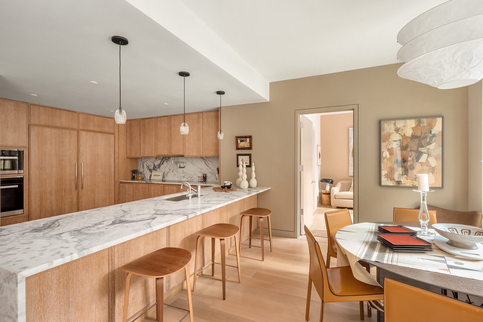 140 West 81st Street, Unit 2B Manhattan, NY 10024 - Photo 5 of 22 a large kitchen with kitchen island a dining table and chairs
