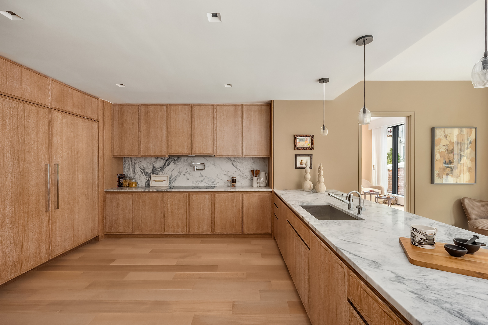 140 West 81st Street, Unit 2B Manhattan, NY 10024 - Photo 6 of 22 a large kitchen with kitchen island white cabinets and stainless steel appliances