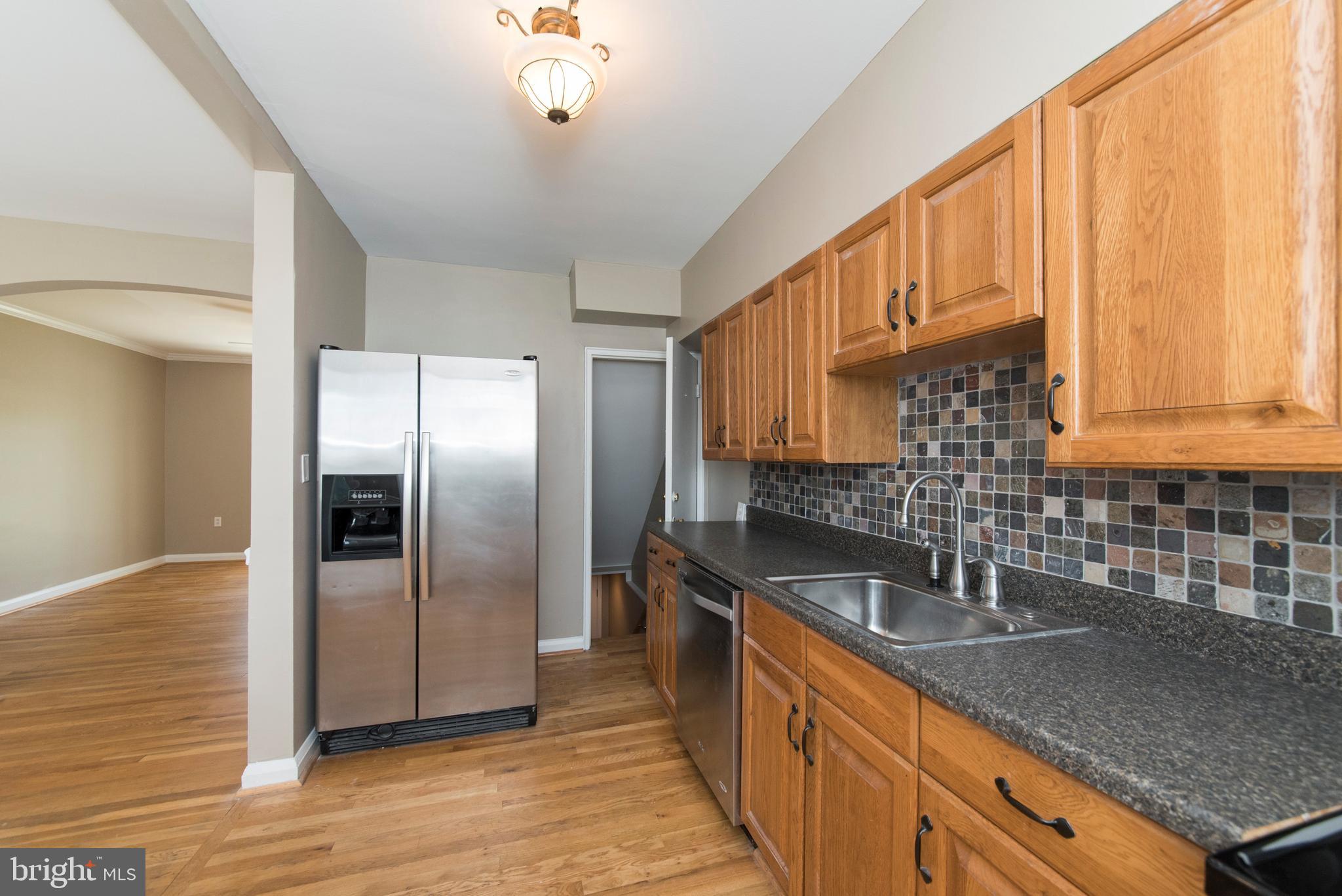 2702 Kirkleigh Road Baltimore, MD 21222 - Photo 11 of 32 a kitchen with stainless steel appliances granite countertop a sink a refrigerator and a granite counter tops