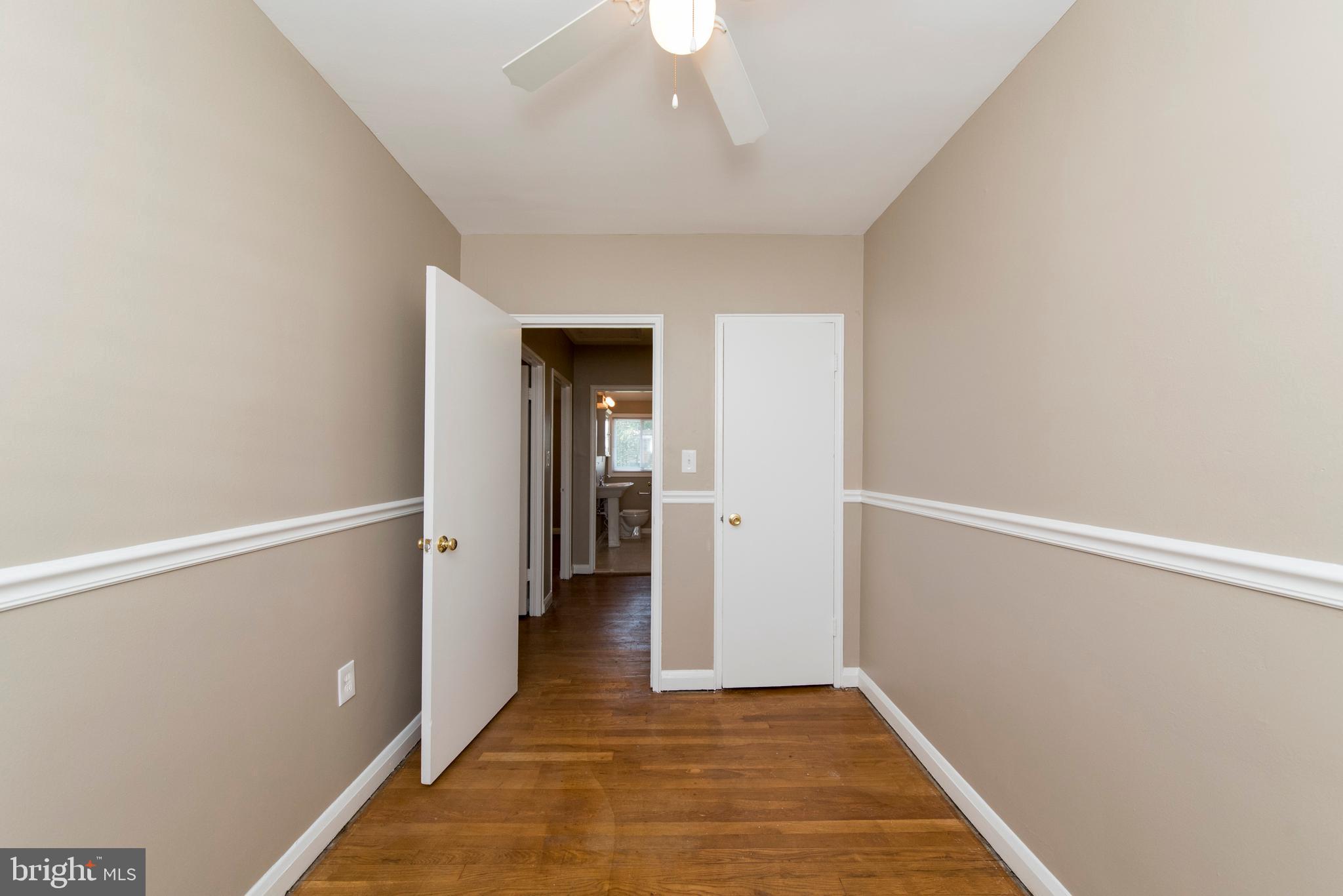 2702 Kirkleigh Road Baltimore, MD 21222 - Photo 18 of 32 a view of a hallway with wooden floor and staircase