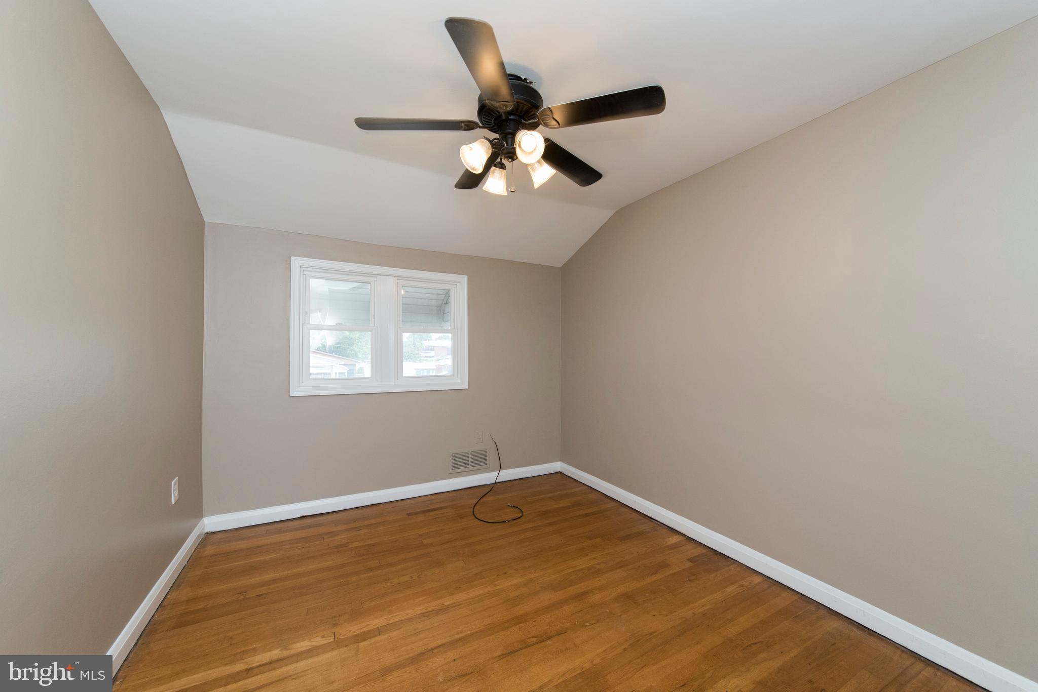 2702 Kirkleigh Road Baltimore, MD 21222 - Photo 22 of 32 a view of empty room with wooden floor