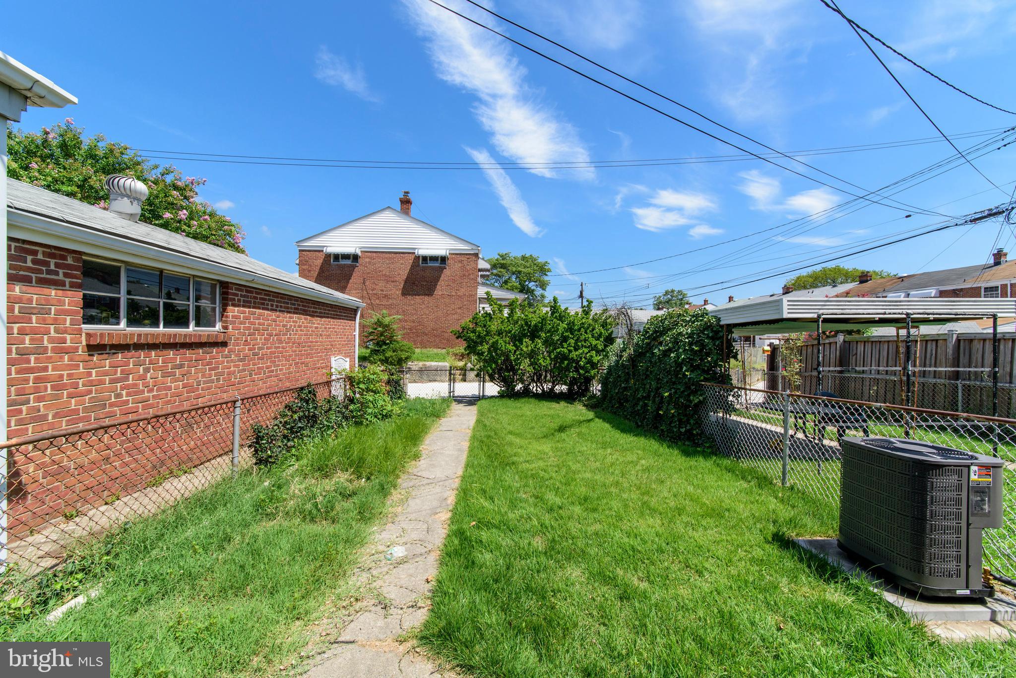 2702 Kirkleigh Road Baltimore, MD 21222 - Photo 24 of 32 a view of a backyard with potted plants and large tree