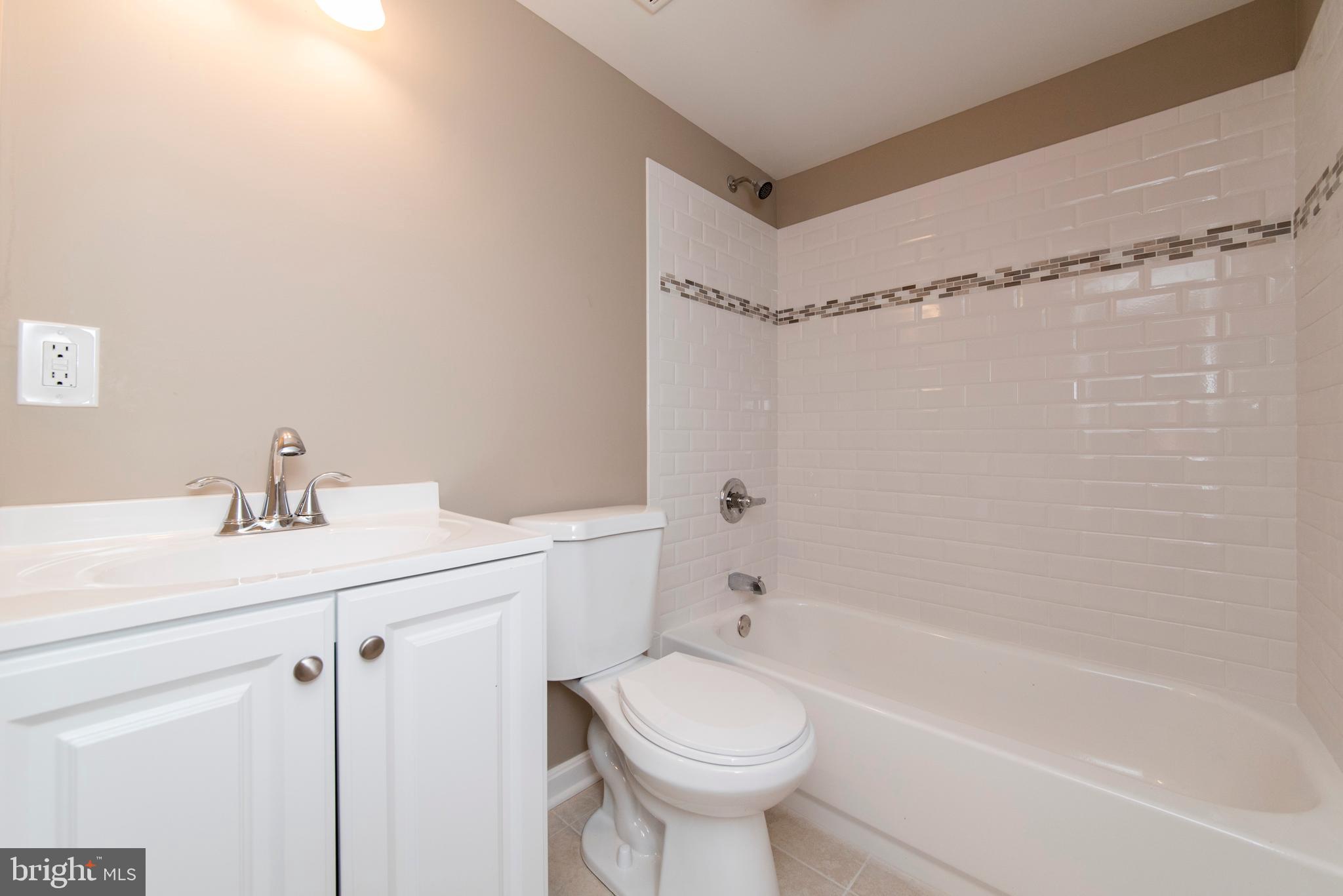 2702 Kirkleigh Road Baltimore, MD 21222 - Photo 28 of 32 a bathroom with a sink a toilet and shower