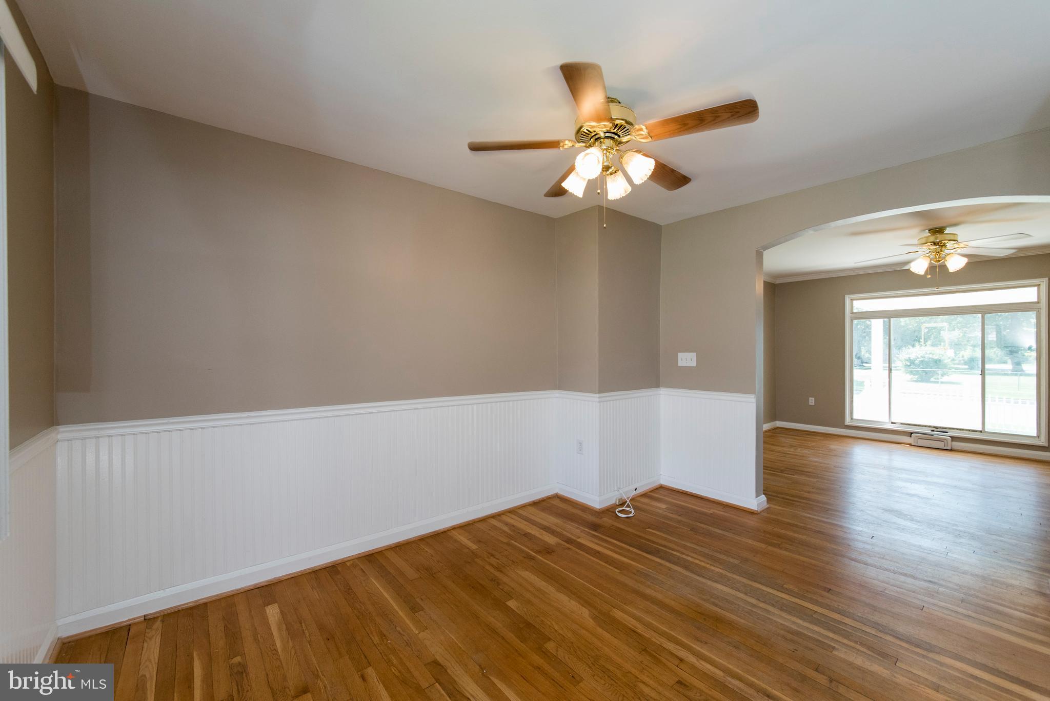 2702 Kirkleigh Road Baltimore, MD 21222 - Photo 6 of 32 wooden floor in an empty room with a window