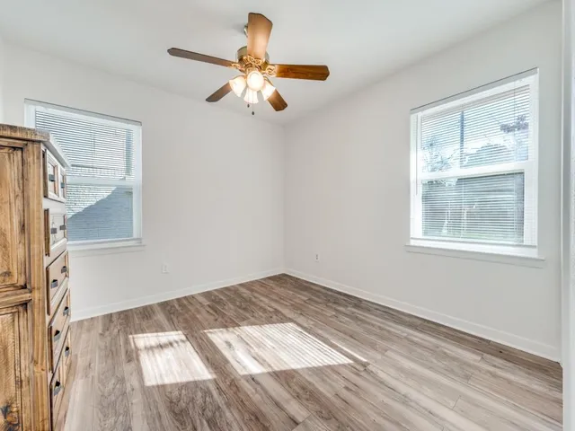 a view of a livingroom with wooden floor and window