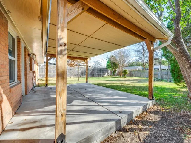 a view of a park with large trees and a small yard
