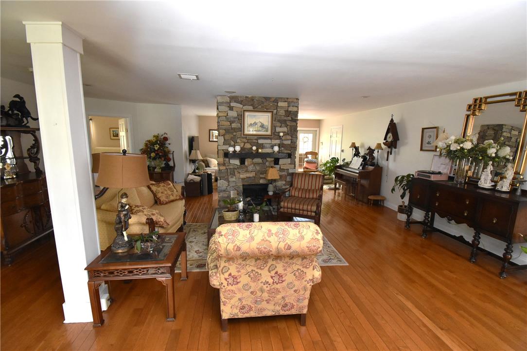 424 Grape Street Whitehall, PA 18052 - Photo 18 of 50 This expansive living area features warm wood floors and a prominent stone fireplace, perfect for gatherings.