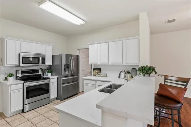 a kitchen with a sink stove and refrigerator