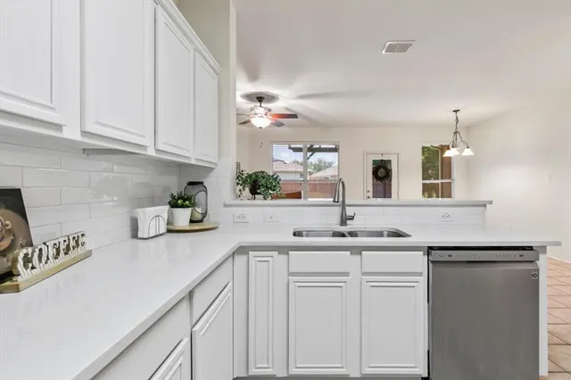a view of washer and dryer with kitchen in the background