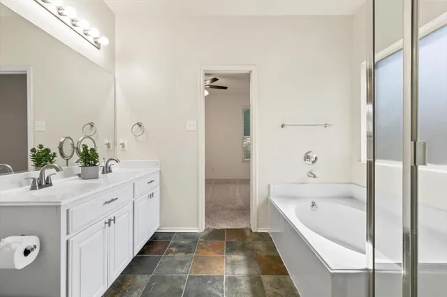 a white bath tub sitting next to a white sink